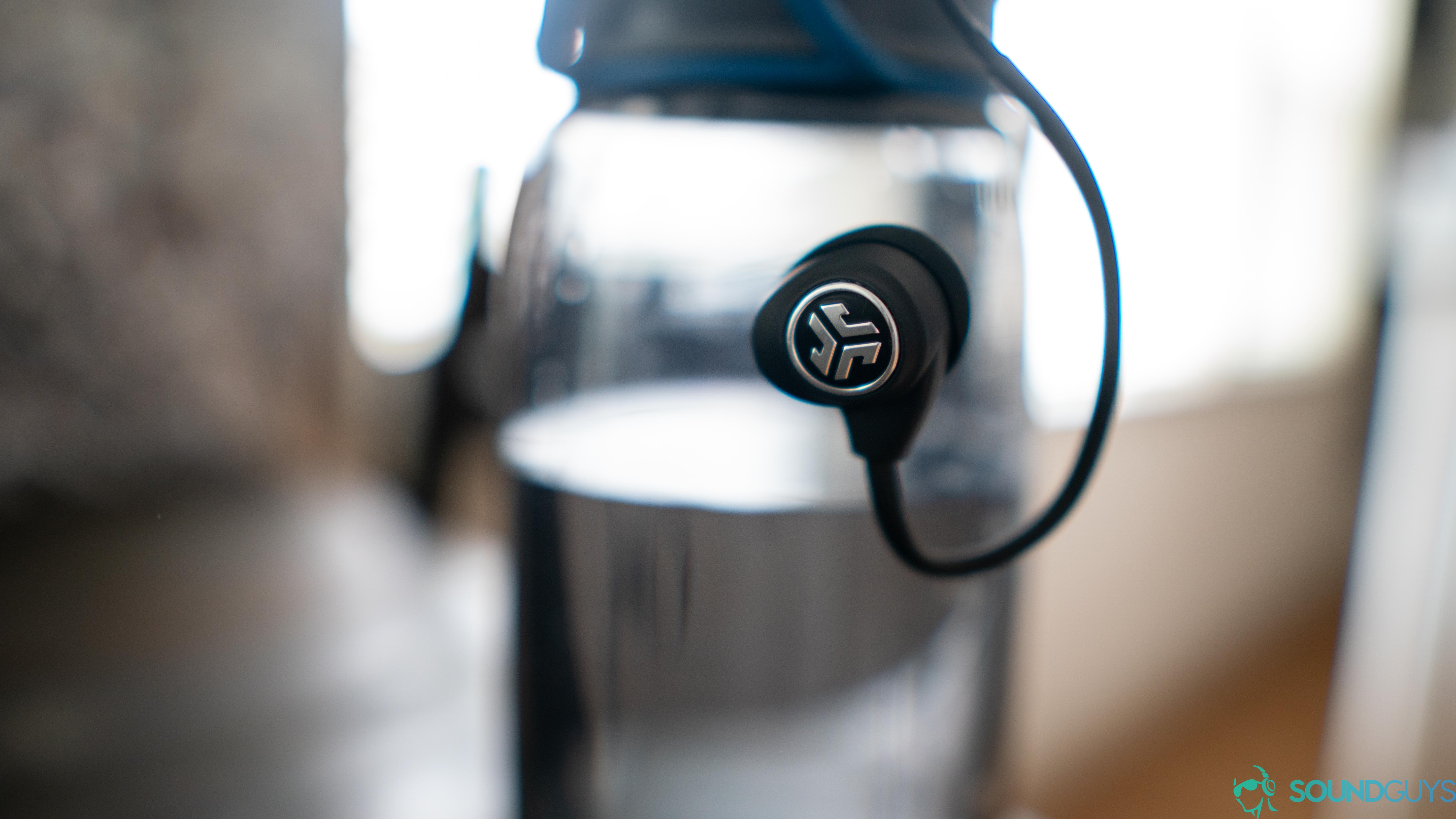 The headphones hanging off a water bottle.