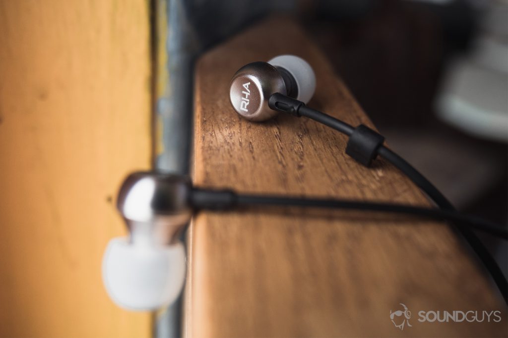Best audio gifts for grads: The earbuds on a wooden railing.