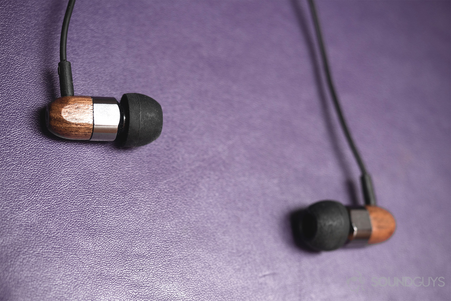 Thinksound ts03+mic review: The earbuds in front of a purple leatherette surface.