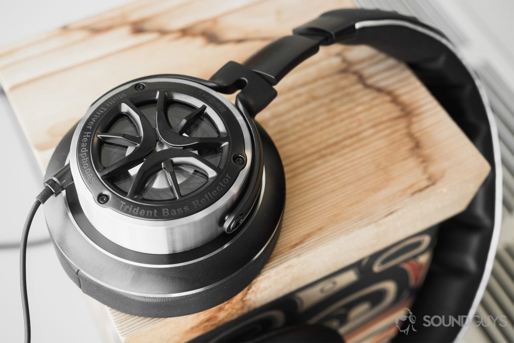 1More Triple-Driver Over-Ear review: A shot of the ear cup on a wooden box.