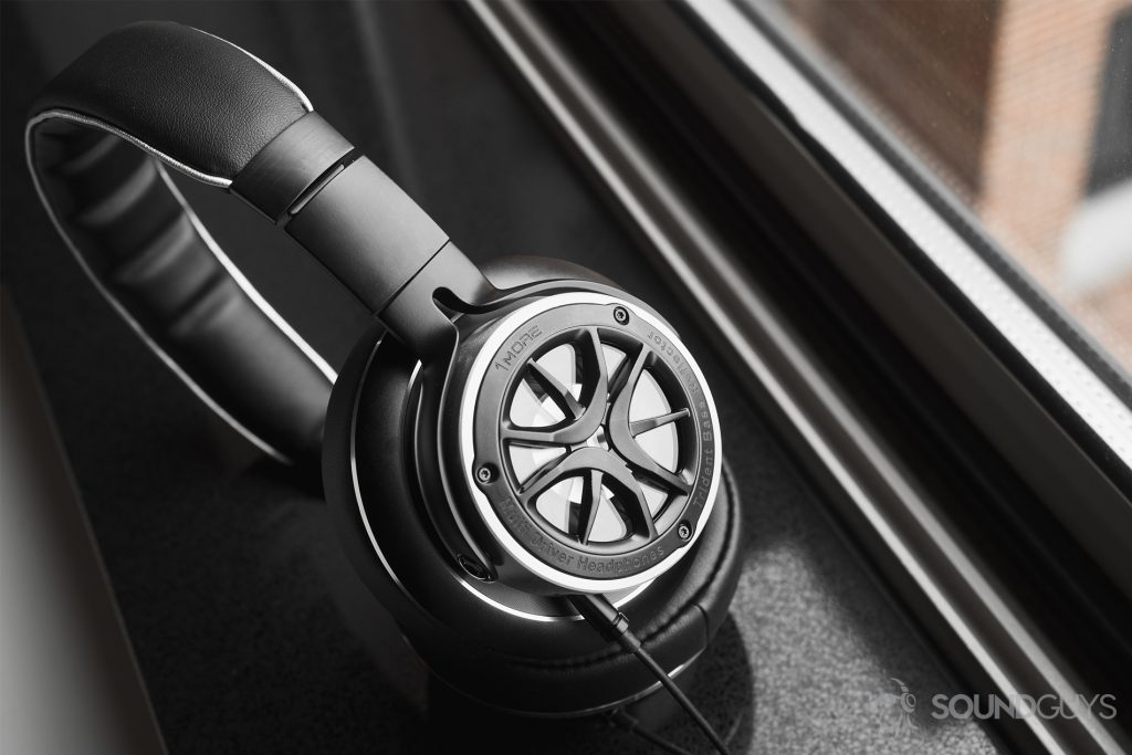 1More Triple-Driver Over-Ear review: The headphones standing at an angle on a black windowsill.