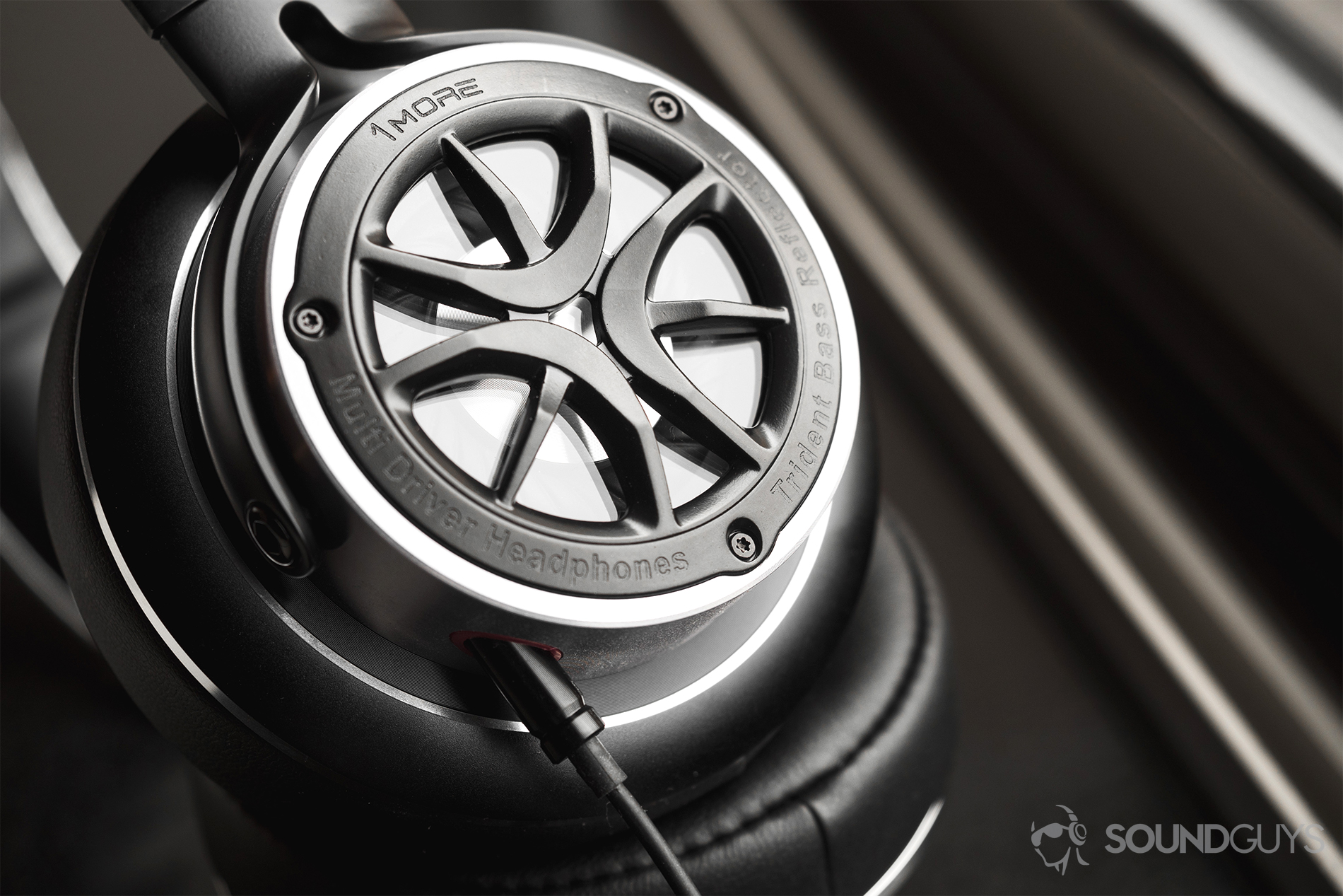 1More_Triple-Driver Over-Ear_LK_5 1More Triple-Driver Over-Ear review: A close-up of the headphones standing at an angle on a black windowsill.