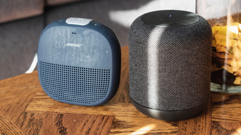 Best Bluetooth speakers under $100: The Bose SoundLink Micro next to the Anker speaker on a wooden surface.