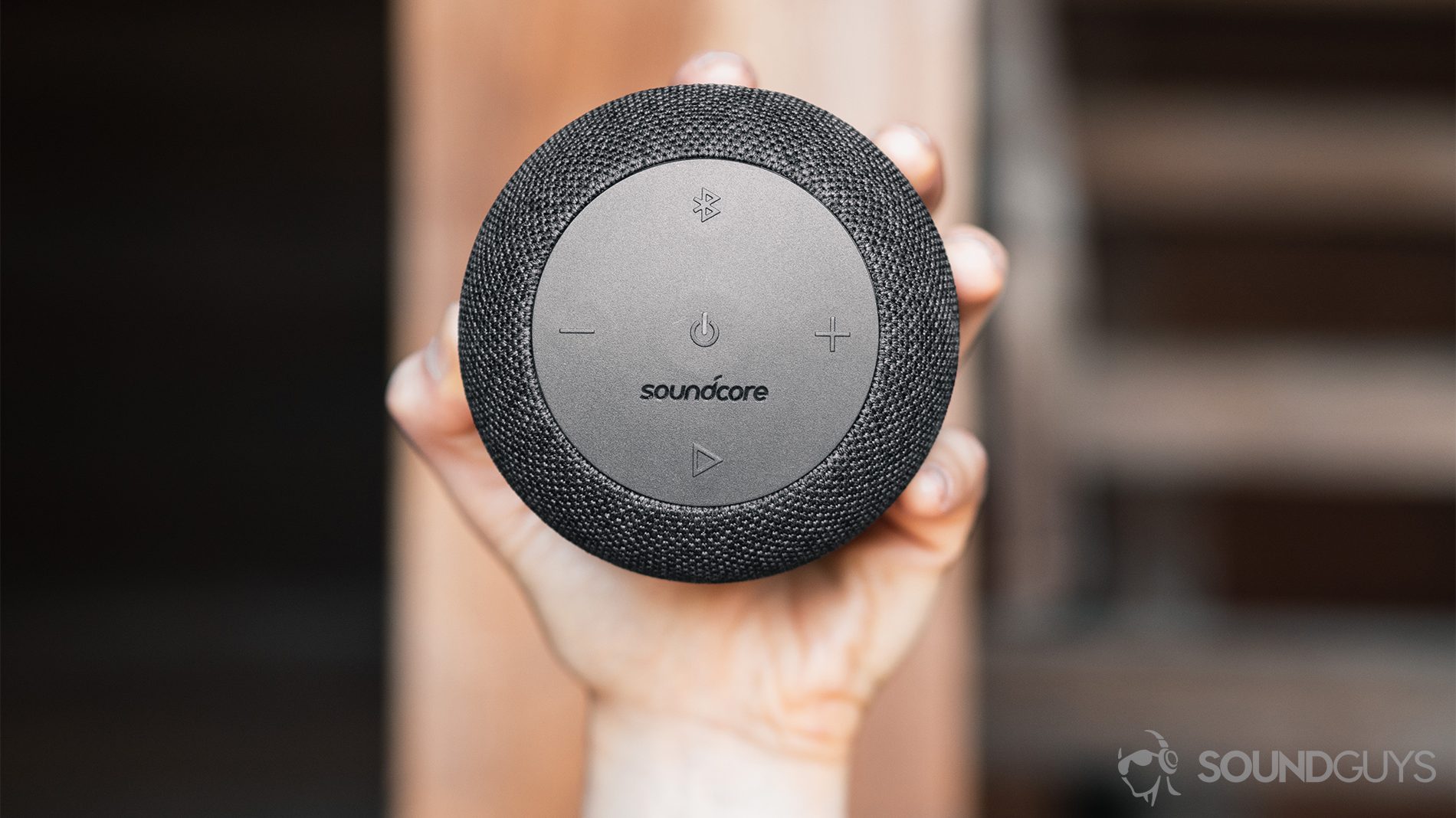 best shower speakers: A straight-on shot of the speaker being gripped in the hand.