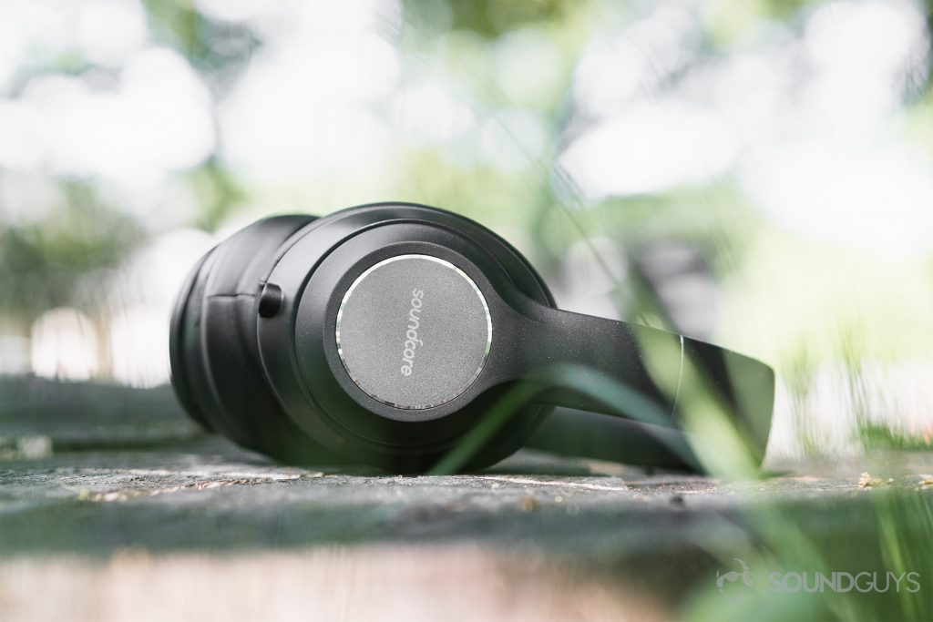 Anker Soundcore Vortex review: An "ant's eye view" of the headphones on a tree stump.