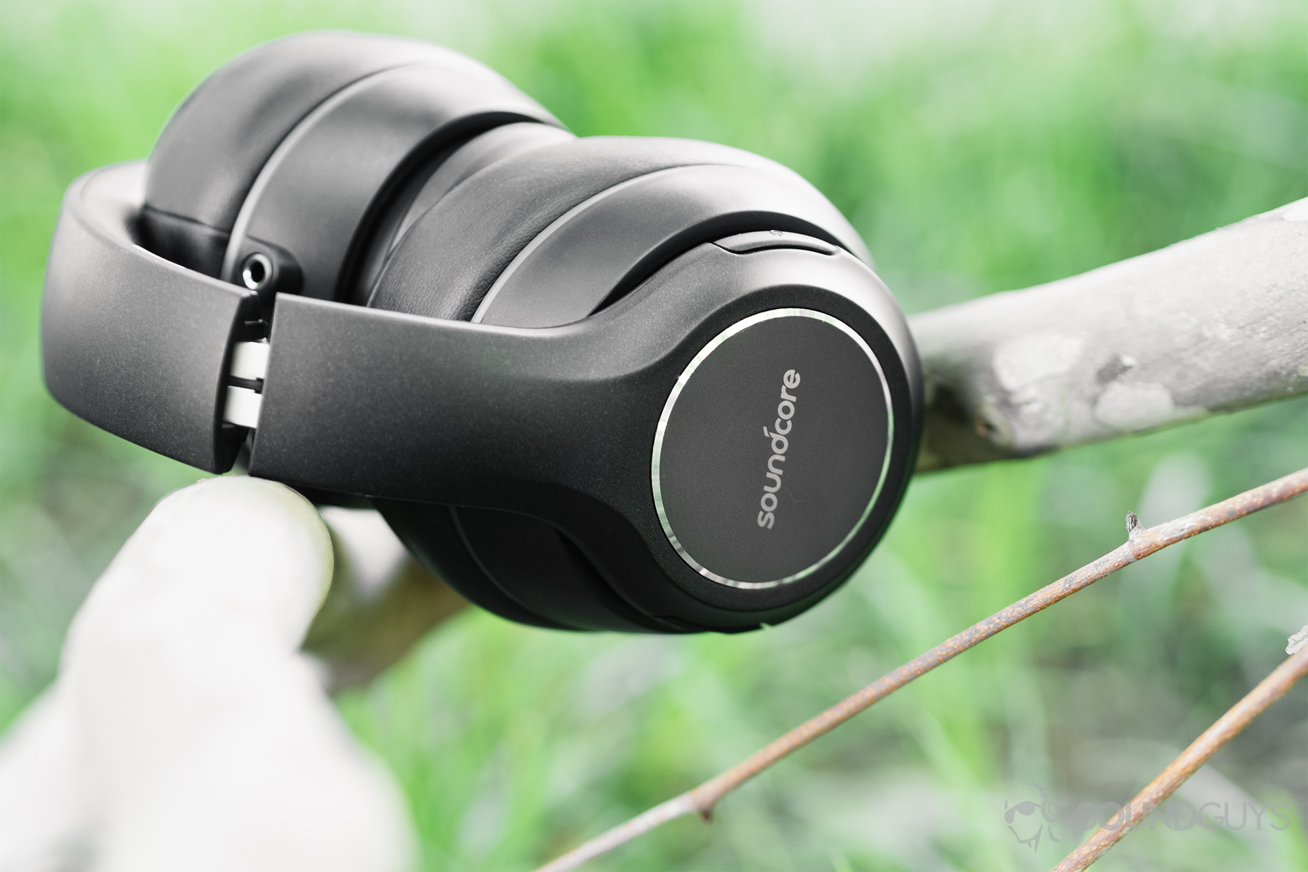 Anker Soundcore Vortex review: The headphones folded and resting between a V-shaped branch.