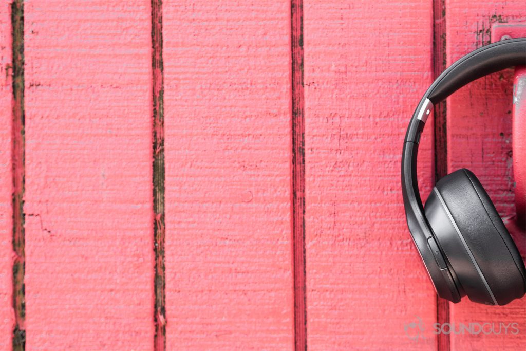 Anker Soundcore Vortex review: A red background with the headphones offset to the right where only one half of the cans are visible.