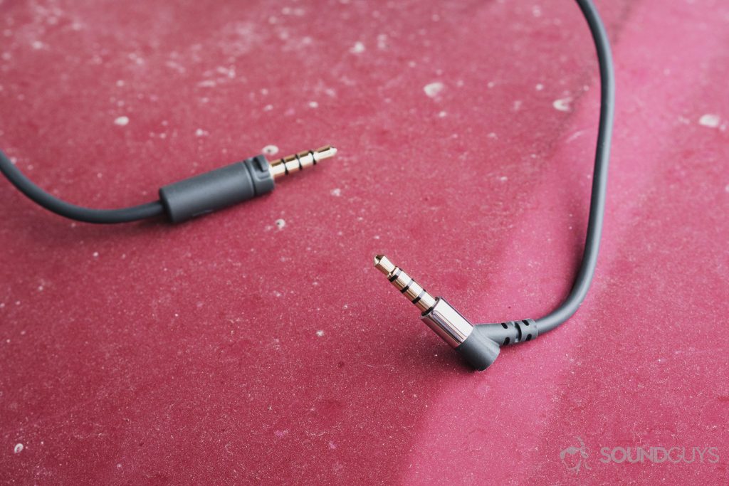 Focal Listen Wireless review: A close-up of the 3.5mm cable on a red steel surface.