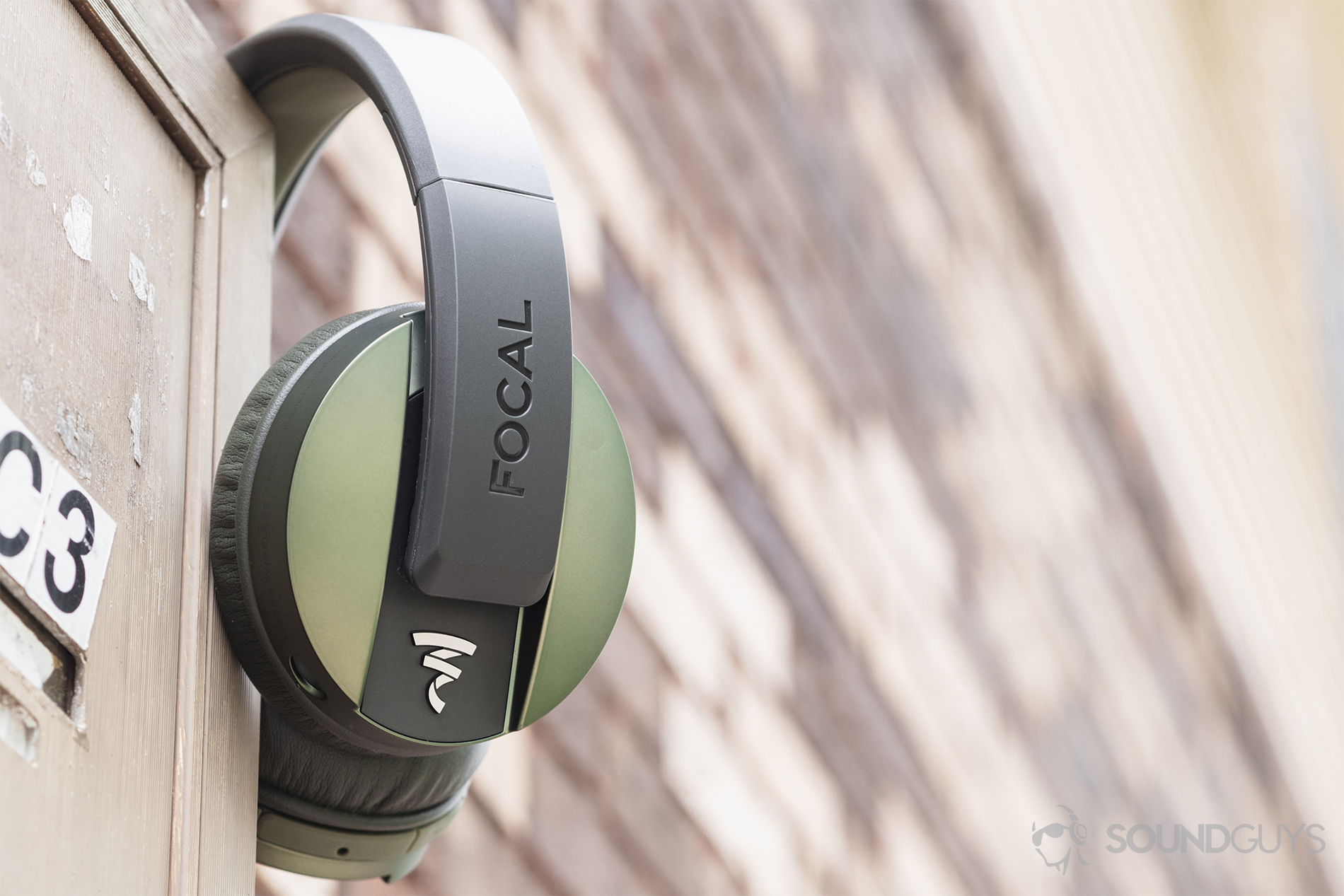 Focal_Listen Wireless_LK_2 Focal Listen Wireless review: The headphones resting on an apartment mailbox against an out-of-focus brick background.
