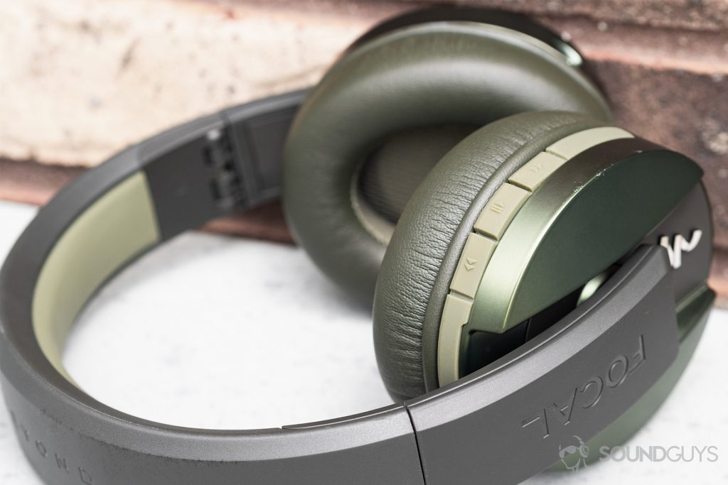 A close up of the Focal Listen Wireless headphones angled away from the camera so the playback controls are clearly visible.