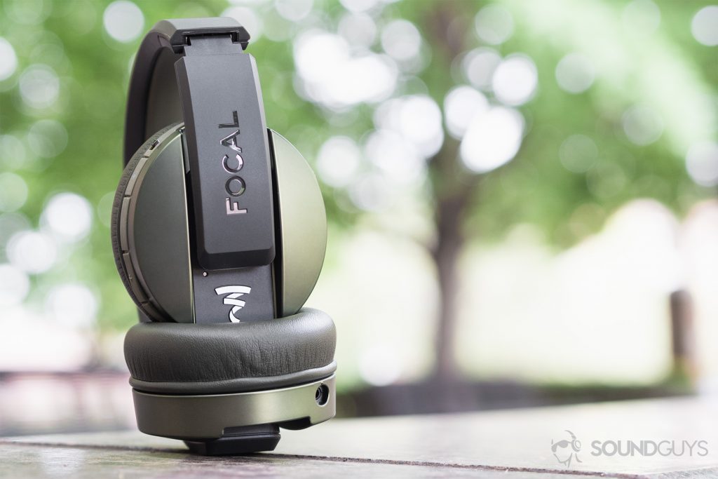 Focal Listen Wireless review: A straight-on shot of the headphones (olive) bent at one of the hinges, showing the Focal branding and logo.