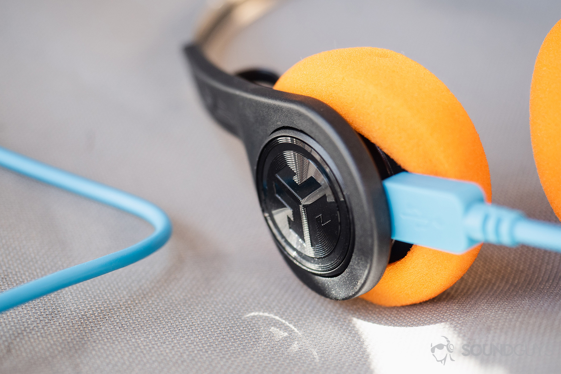 JLab Rewind Wireless Retro: The blue micro-USB is plugged into the headphones with oragne foam pads.
