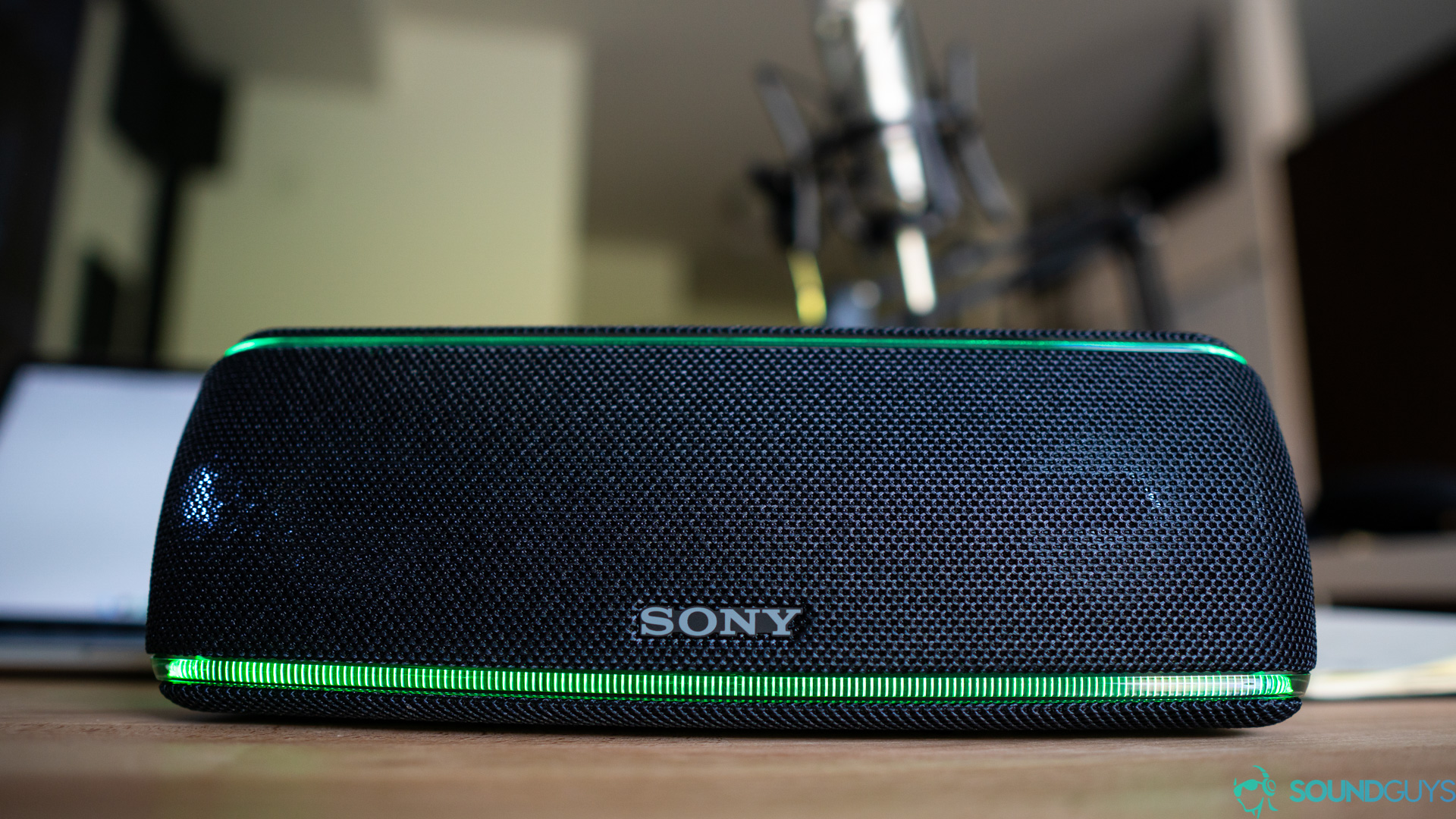 The XB41 speaker with its lights shining sitting on a desk. 