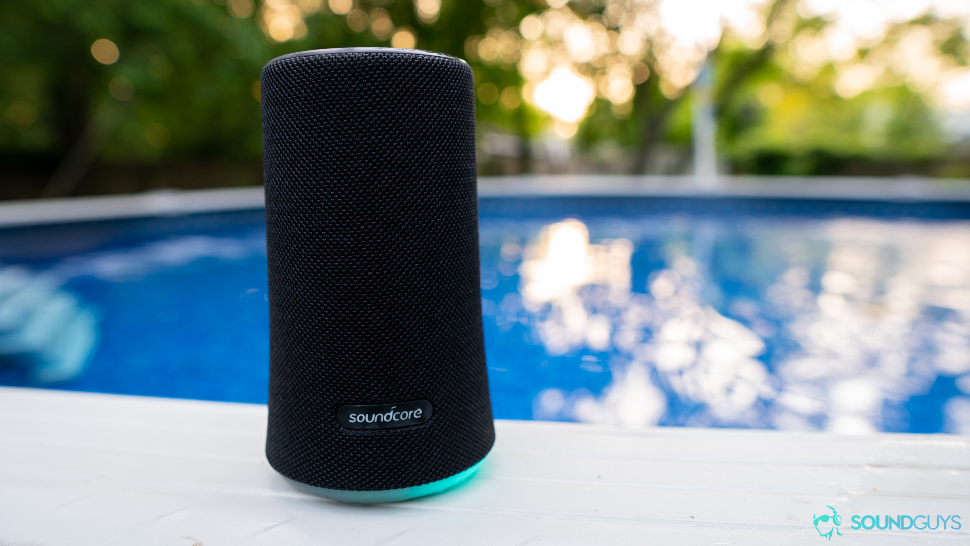 The Anker Soundcore Flare pictured on the ledge of a pool.