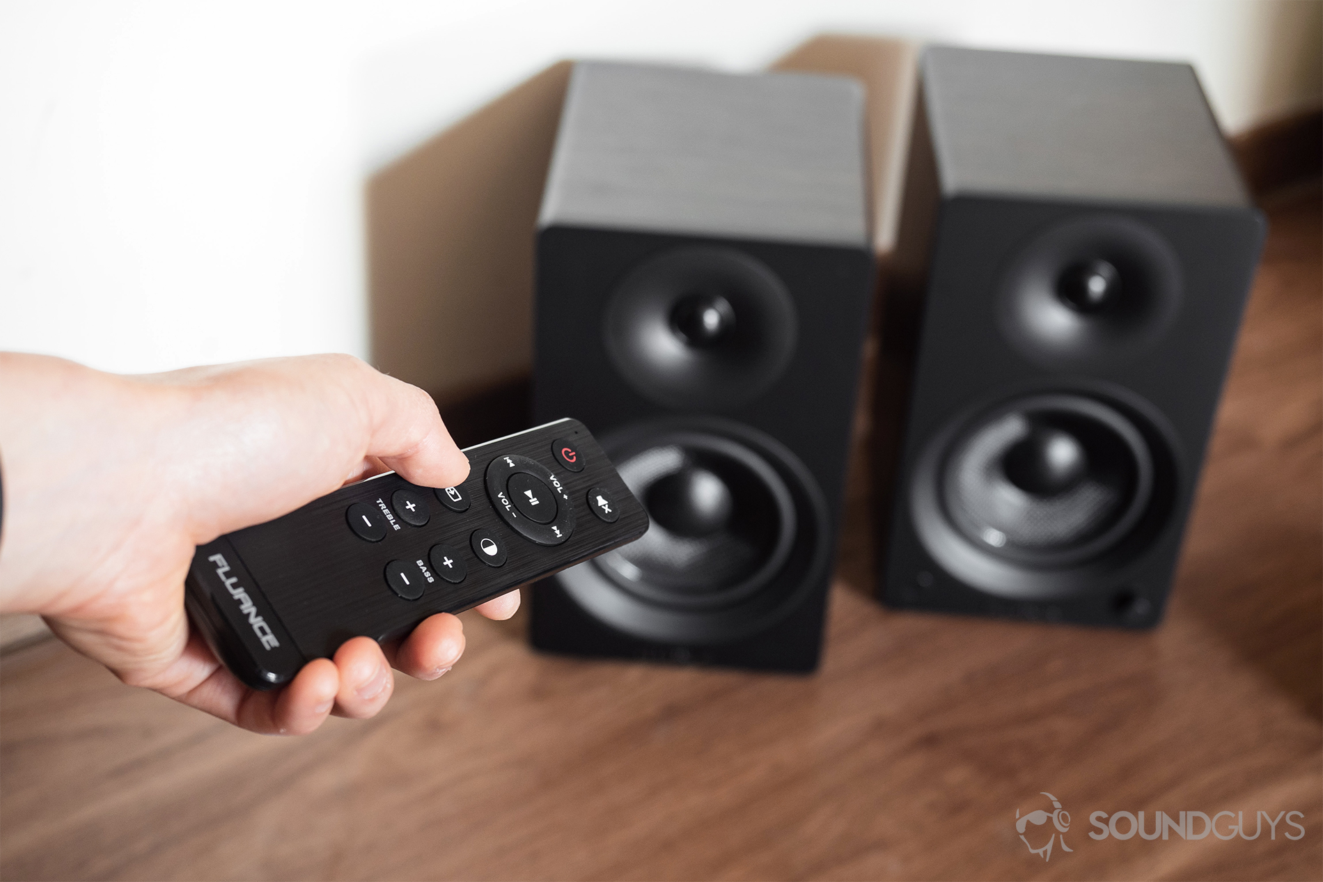 Fluance Ai40 review: The remote being used to make adjustments to the speakers.