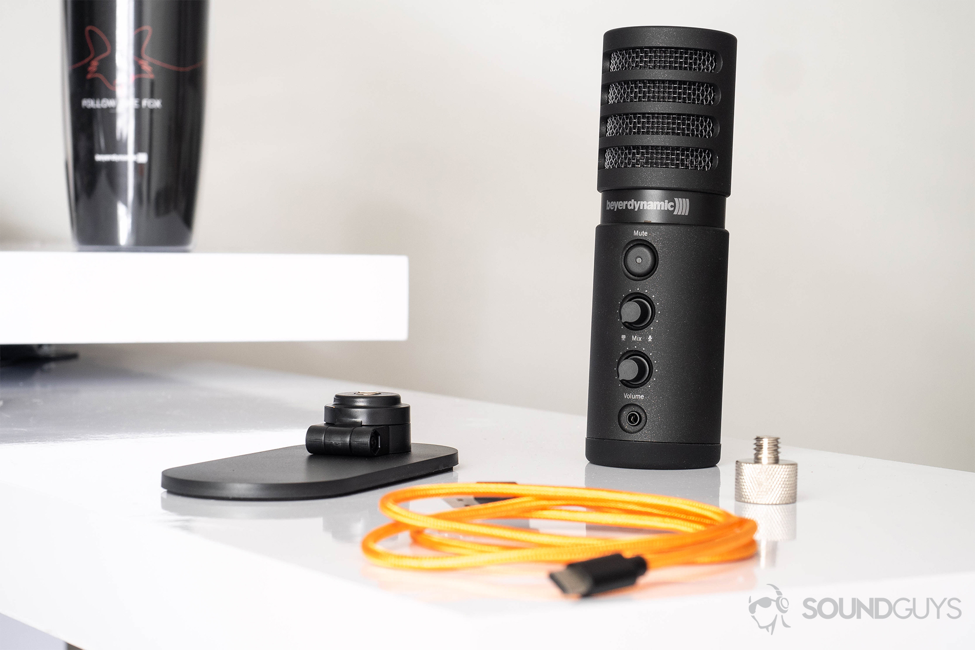Beyerdynamic_Fox USB mic-1 Beyerdynamic Fox USB microphone: The microphone on a white desk with the orange cable in front and the base adjacent.