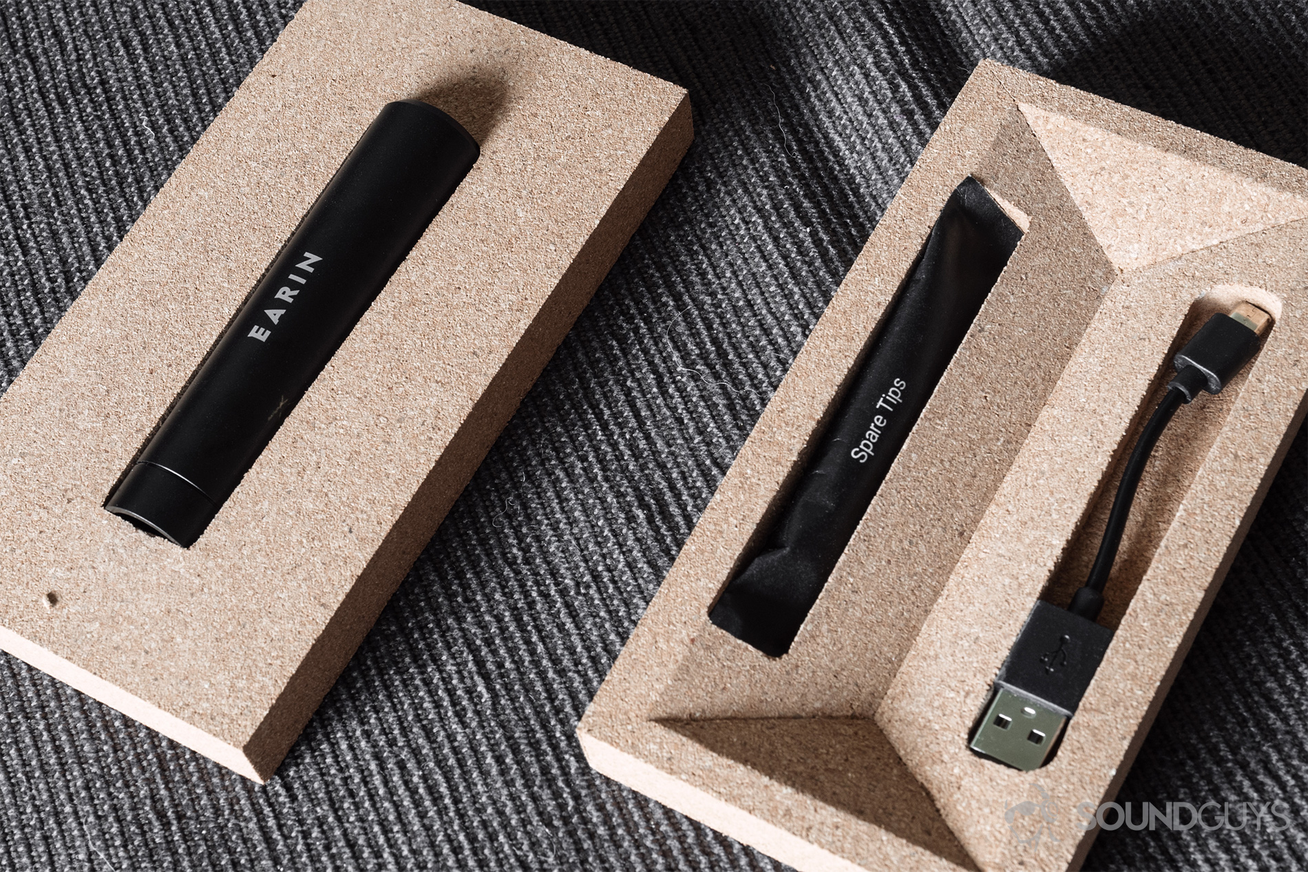 Earin M-2 review: The capsule, ear tips, and micro-usb cable in the cork packing.