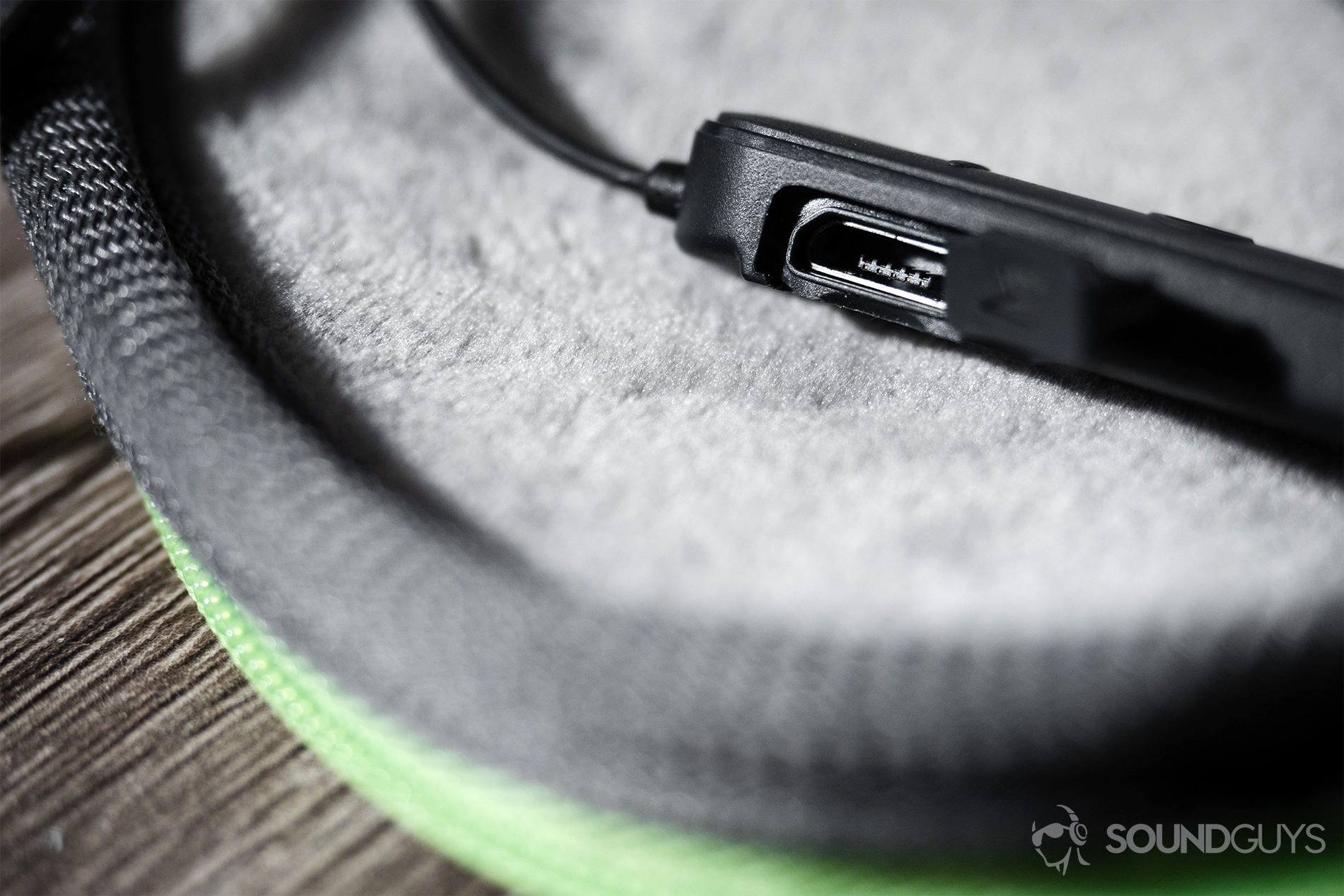Optoma NuForce_Be Sport4-7 Optoma NuForce Be Sport4: A close-up of the micro-USB input with the headphones in the soft, zipper carry case.