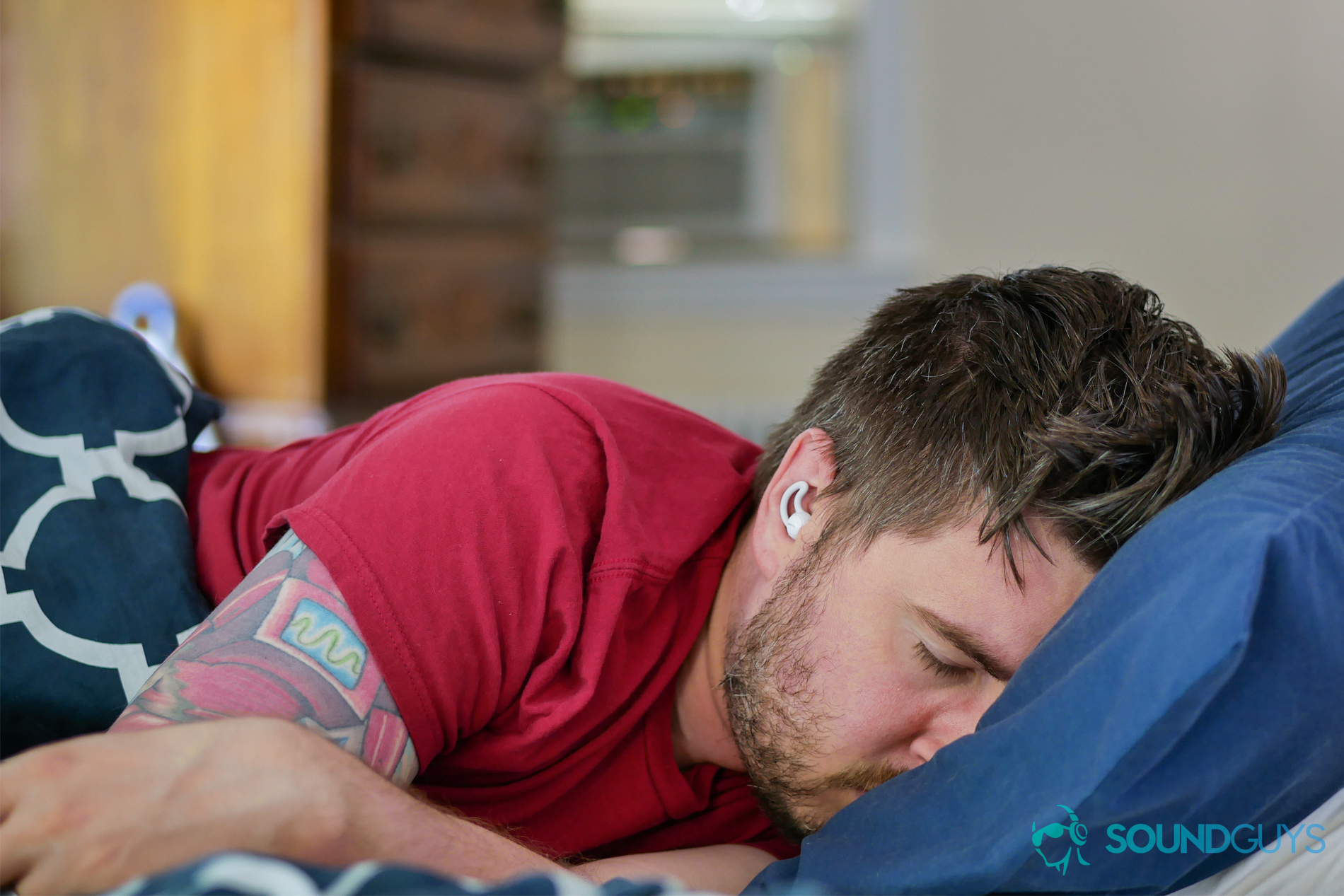 bose-sleepbuds-chris-pillow A photo of Chris sleeping in a bed, while using the Bose sleepbuds near an air conditioner.