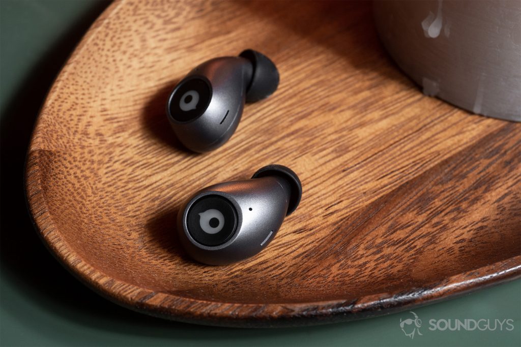 An image of the earbuds on a wood surface.