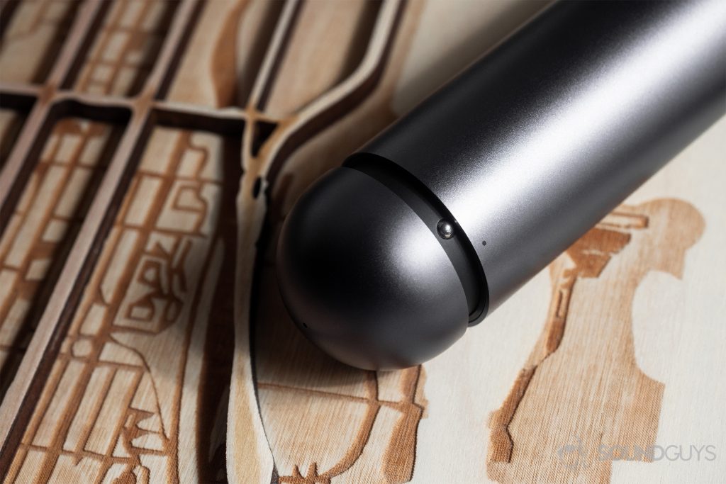 A close-up of the capsule charging case showing the resistance knob that locks the case closed.