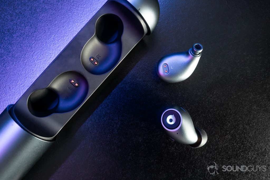 A top-down image of the earbuds with purple lighting on a black surface.