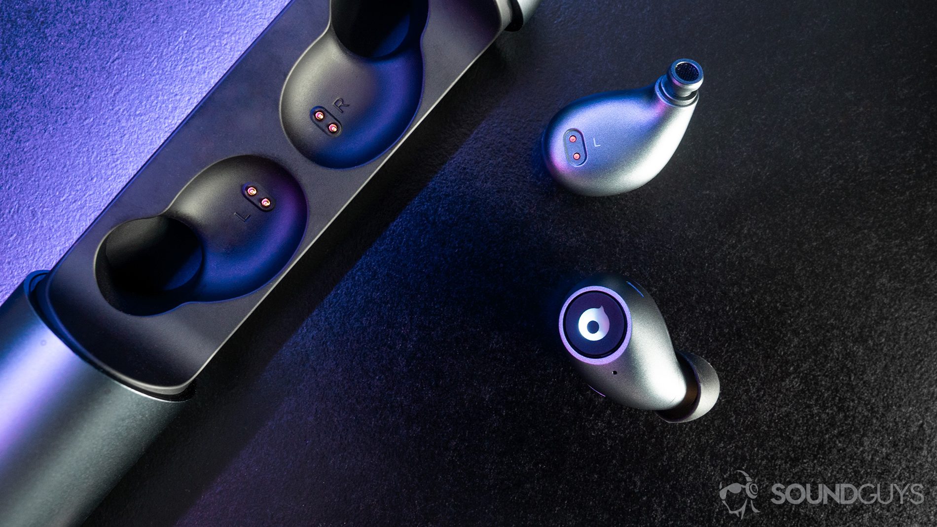 Crazybaby_Air 1S-8 A top-down image of the earbuds with purple lighting on a black surface.