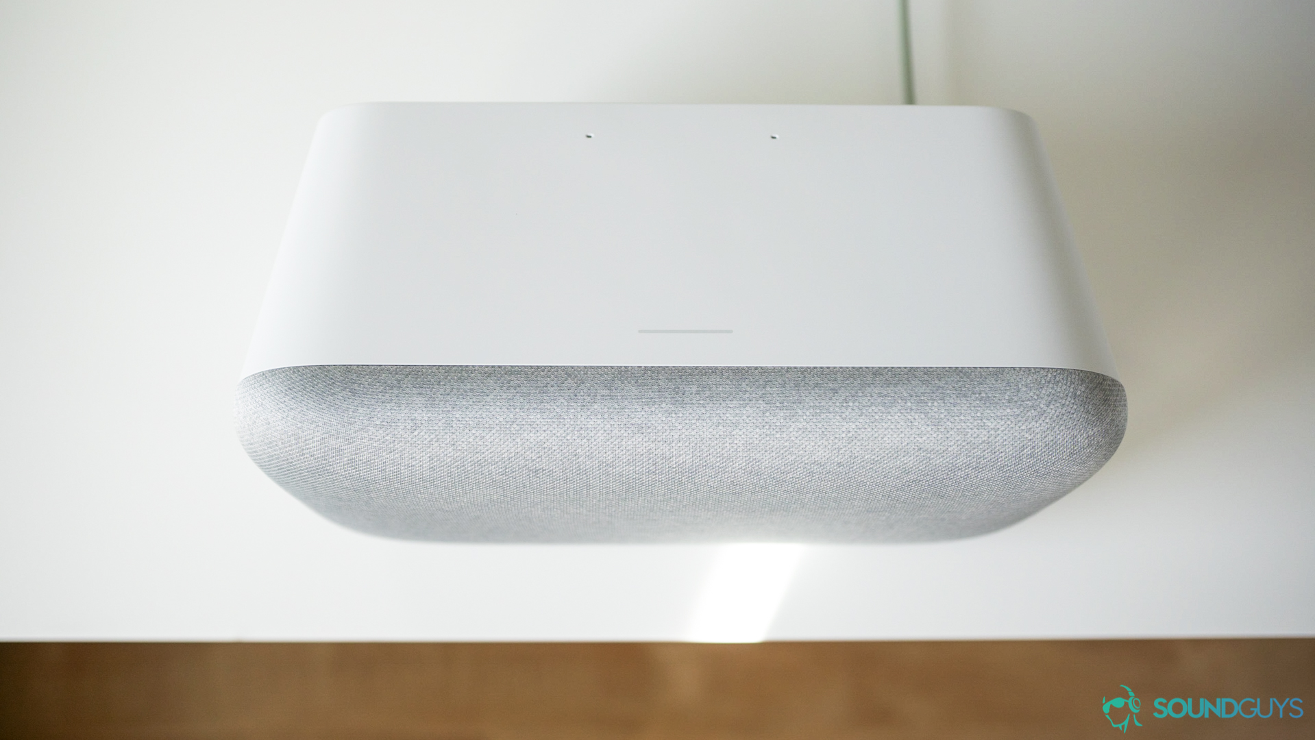 The touch sensitive part of the Google Home Max is a gray strip.