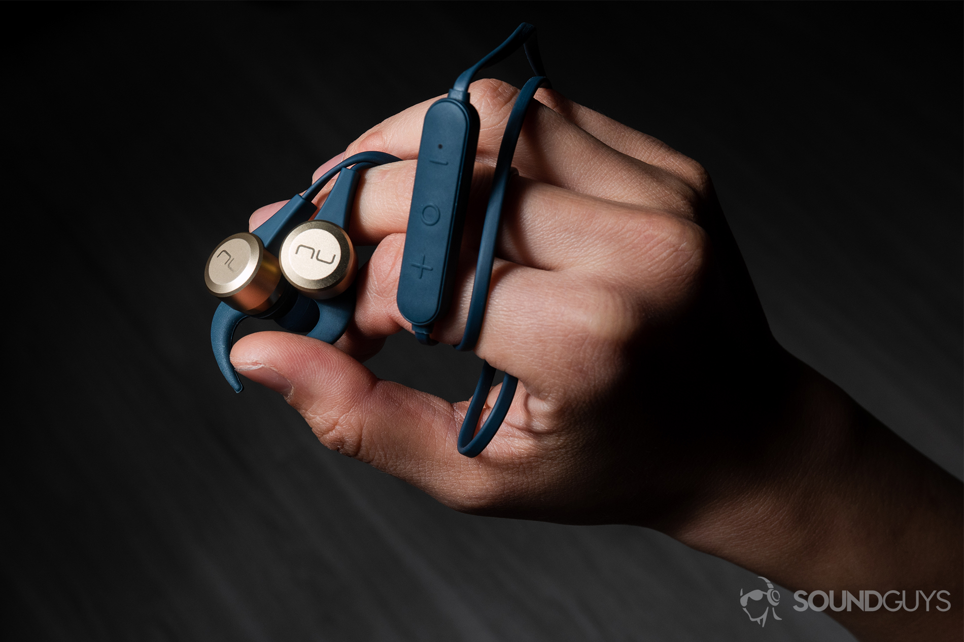 Optoma NuForce Be Live5: The earbuds with the wire wrapped around the hand.