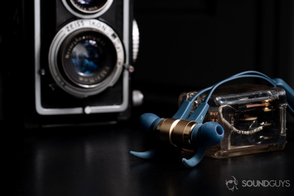 Optoma NuForce Be Live5: An image of the earbuds magnetized together with an Ikoflex camera in the background.