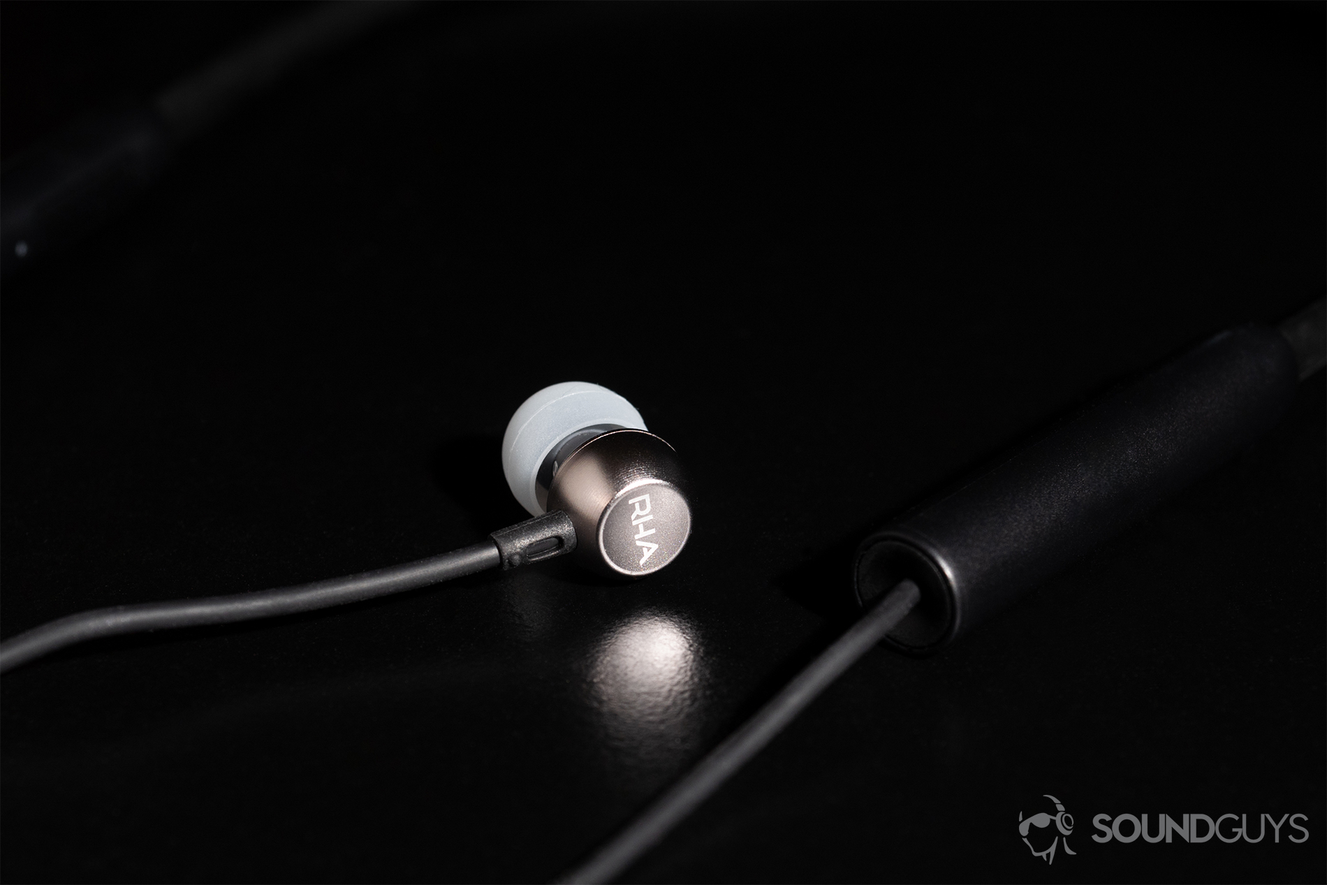 RHA MA390 Wireless: A close-up of one of the earbuds with the RHA logo facing the camera.