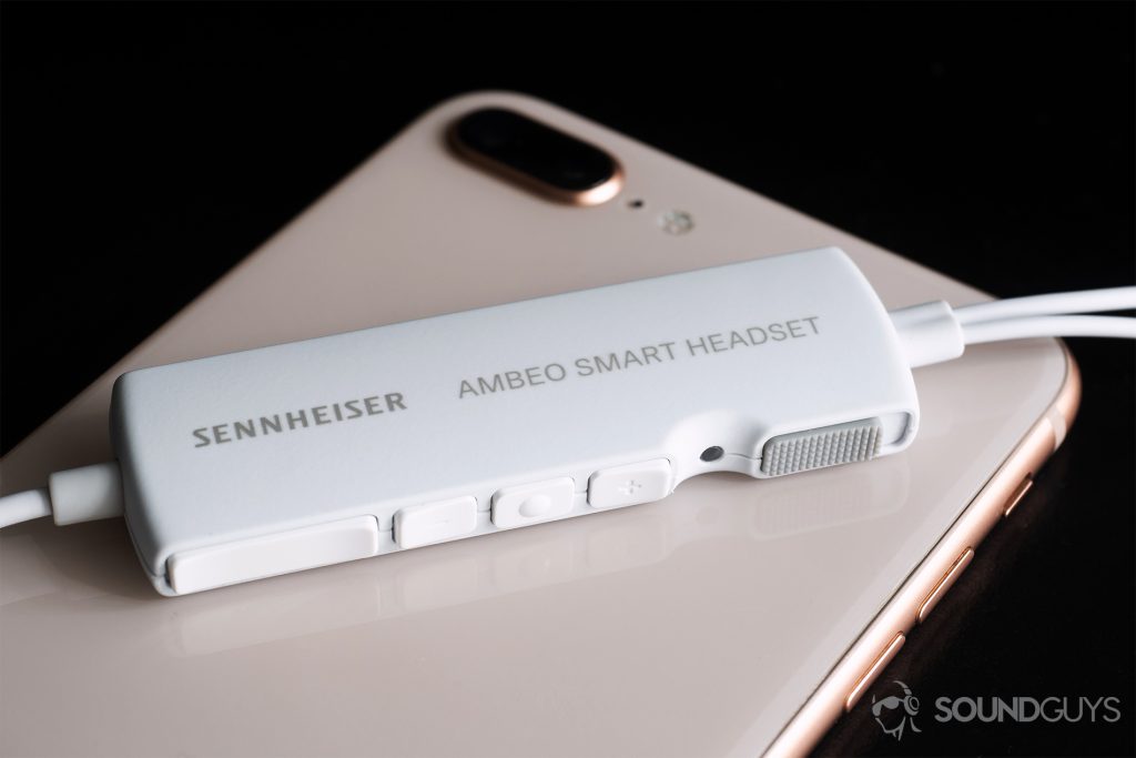 Sennheiser Ambeo Headset: A slightly angled image showing off the control module and all of its toggles. It rests on an iPhone 8 Plus.