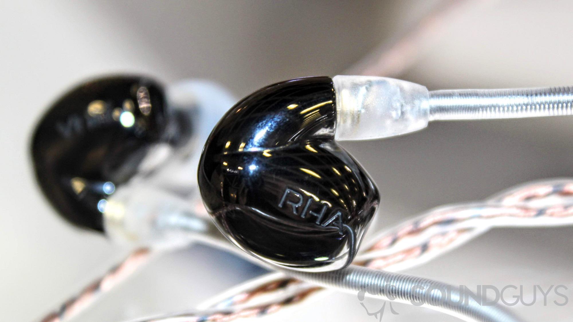 The RHA CL2 Planar headphones on a glass cabinet close-up.