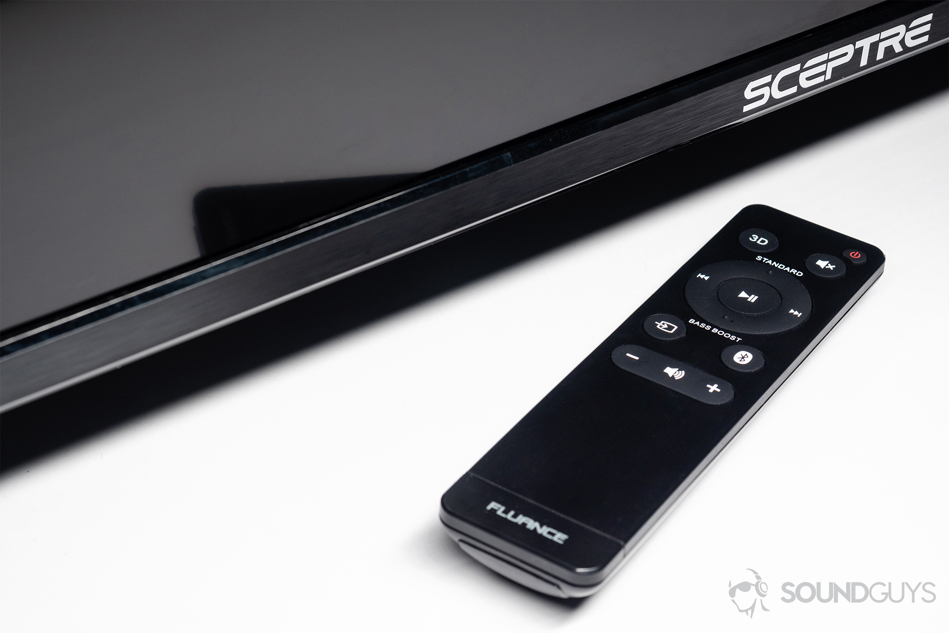 Fluance AB40 review: A top-down angled image of the Fluance remote nextto a Sceptre TV.