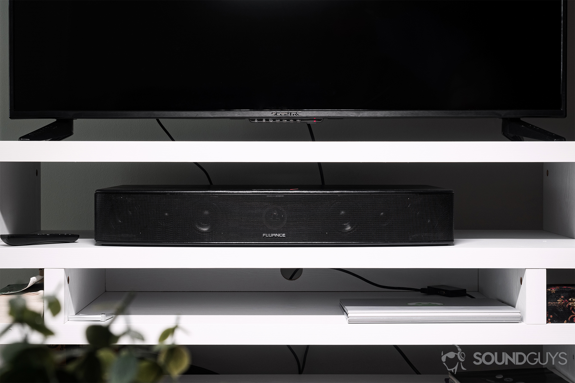 Fluance_AB40-2 Fluance AB40 review: The soundbar resting in a TV stand beneath a 55" TV.