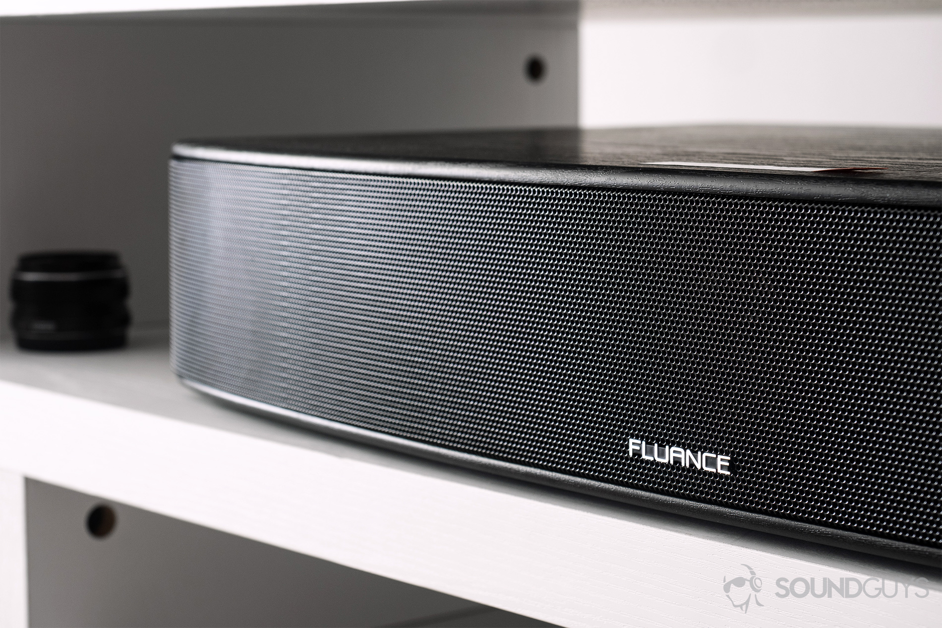 Fluance AB40 review: An angled image of the soundbase on a white wooden TV stand.