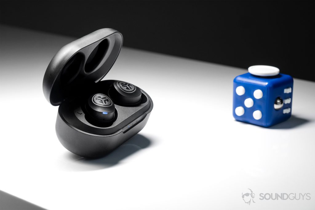 A picture of the JLab JBuds Air true wireless workout earbuds (black) in the charging case, which is angled slightly away from the camera.