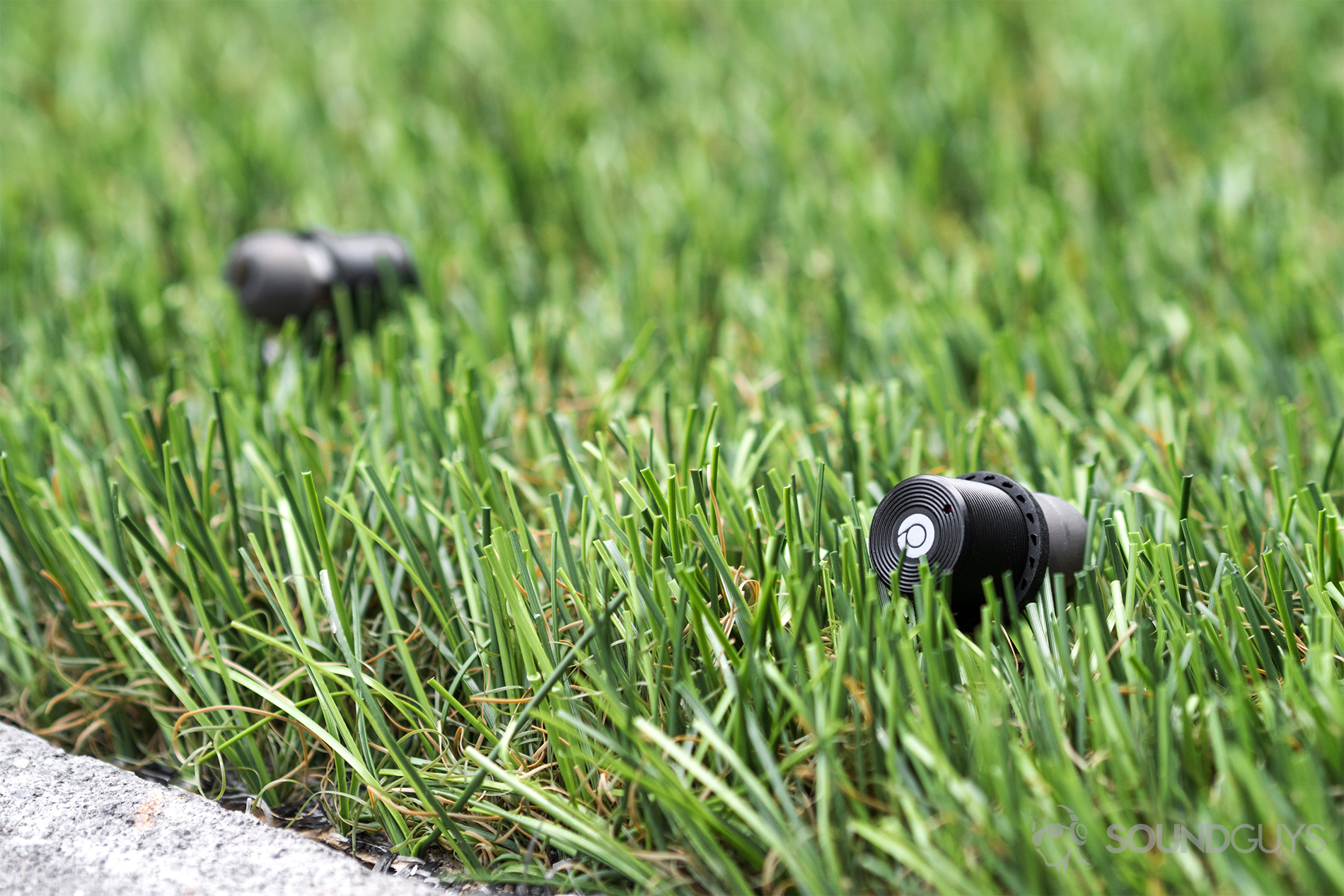 Rowkin Ascent Charge+ review: The earbuds resting in Astro-Turf.