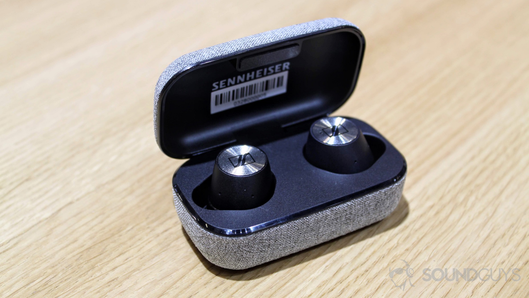 Sennheiser Momentum True Wireless earbuds in an open case.