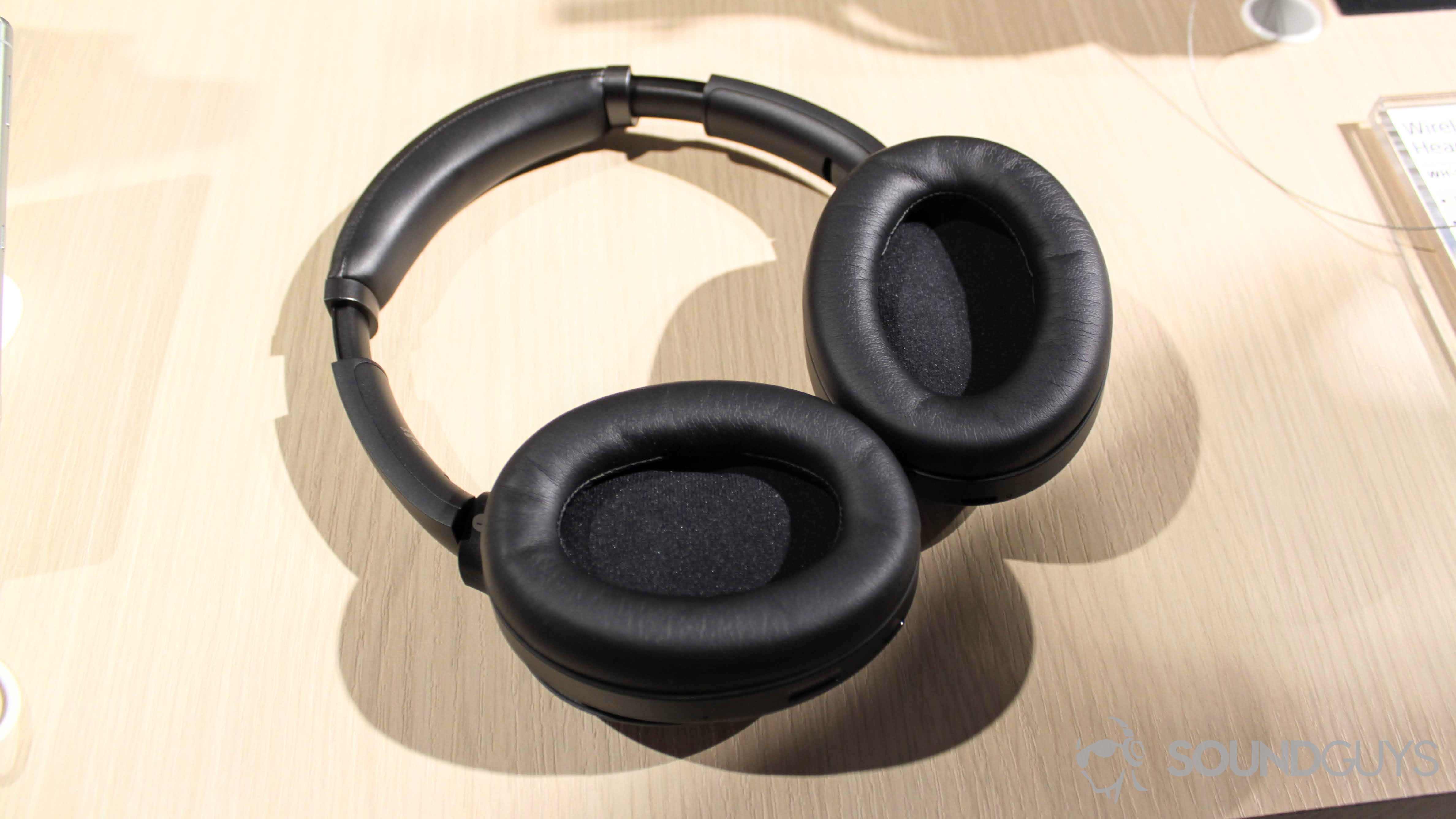 Sony WH-1000XM3 headphones with earpads facing up on a table.
