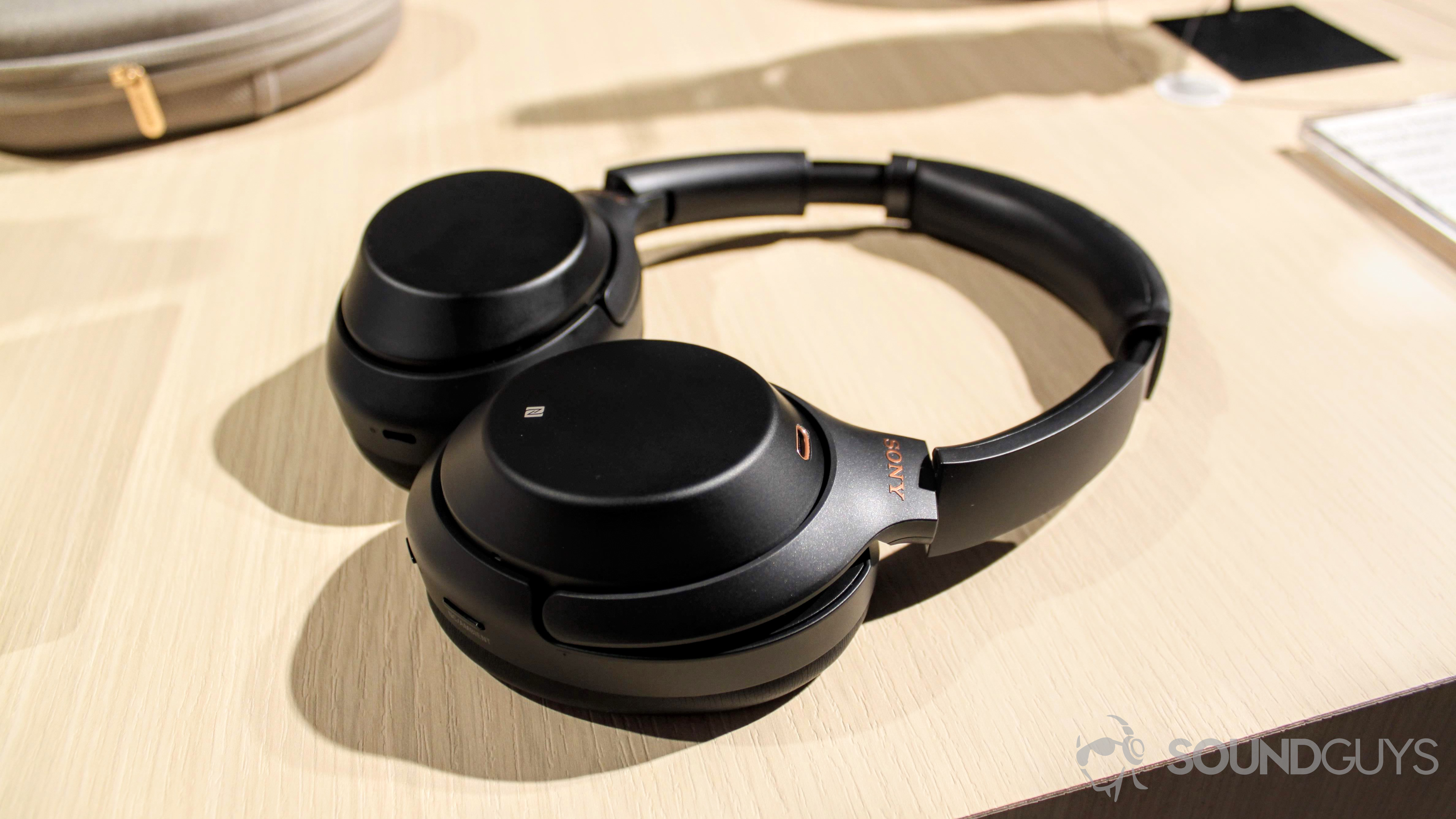 Sony WH-1000XM3 headphones with earpads facing down on a table.