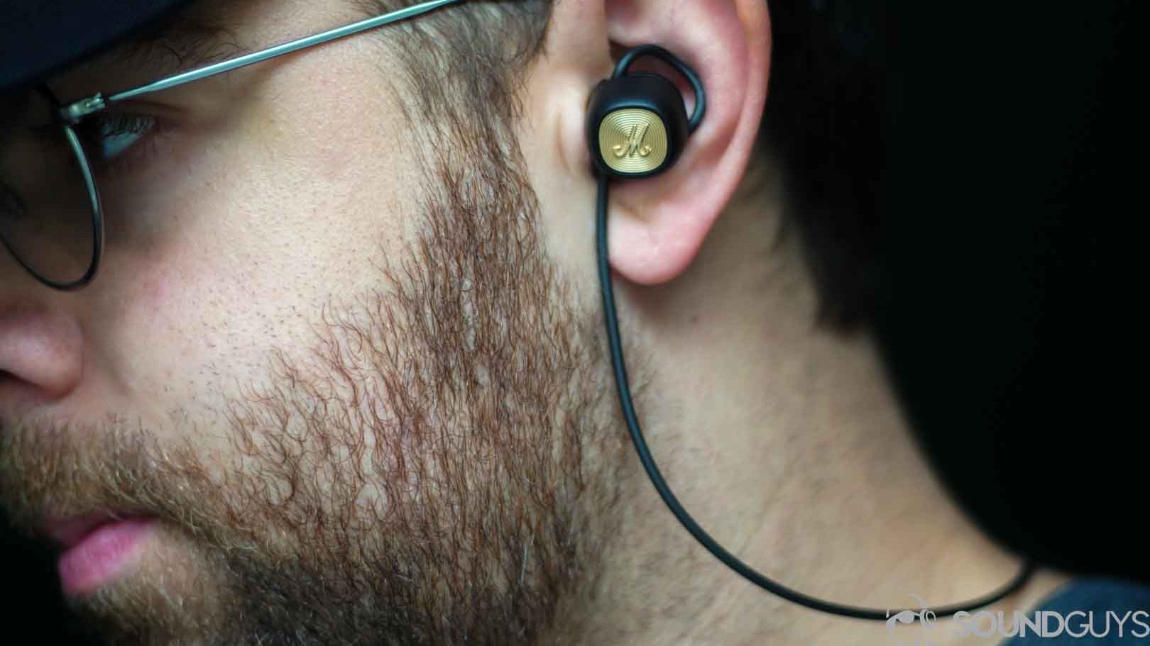 Picture of Adam wearing the Marshall Minor II earbuds. 