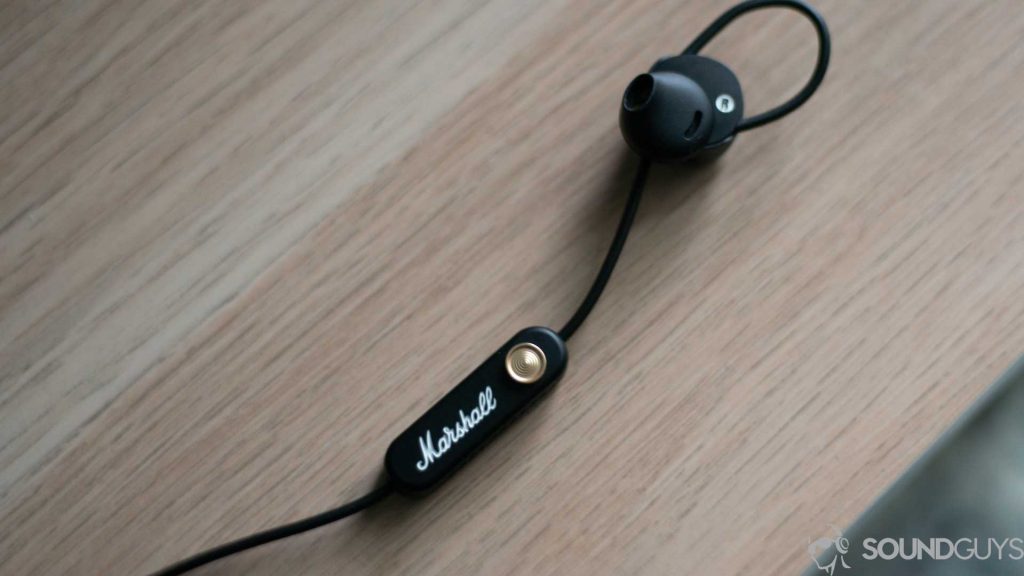 Pictured are the Marshall Minor II earbuds flat on a desk.