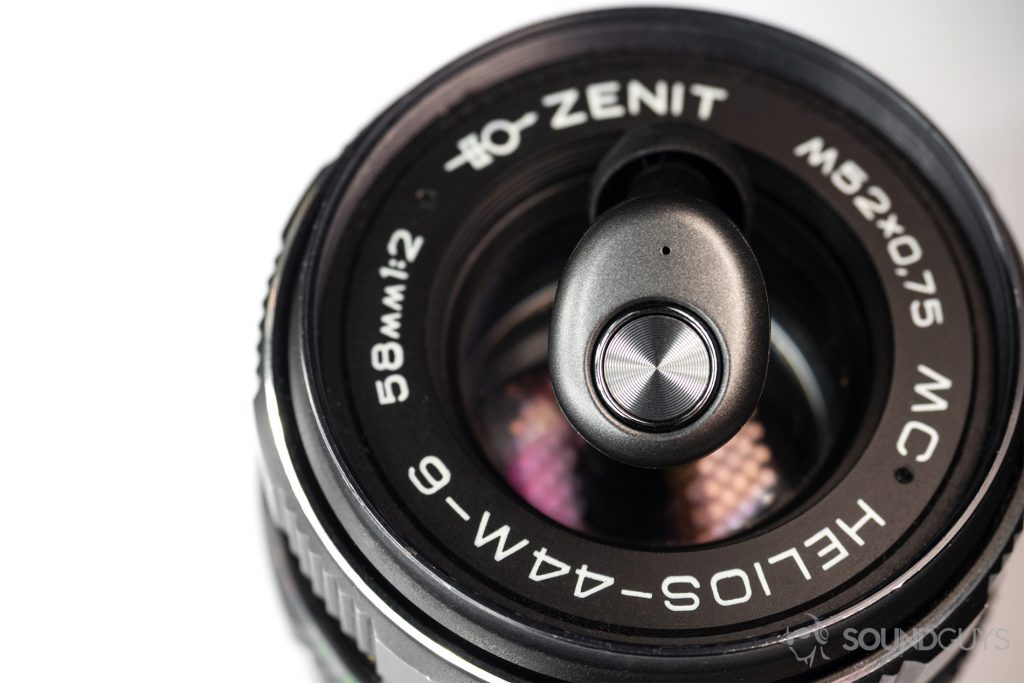 Monoprice True Wireless: The earbud resting directly on a camera lens.