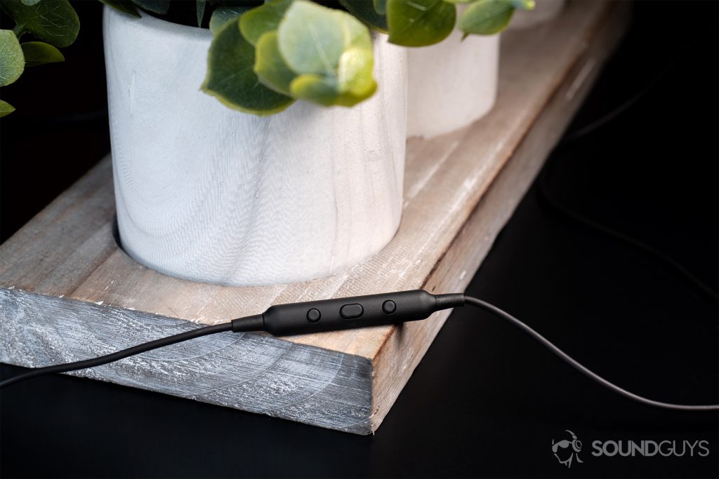 AiAiAi Pipe 2.0: The in-line mic and remote resting on a surface holding artificial potted plants.