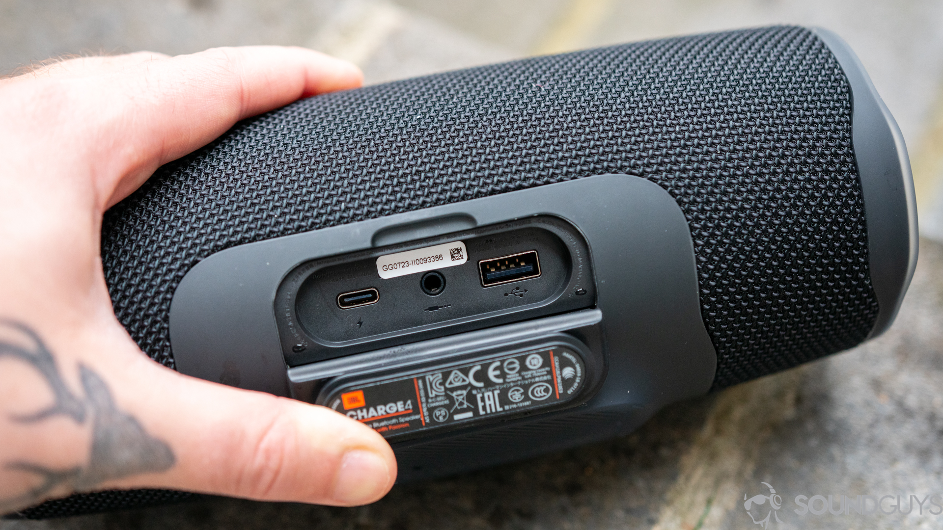 Pictured are the USB-C, 3.5mm, and USB-A ports of the black JBL Charge 4 behind the waterproof flap. 