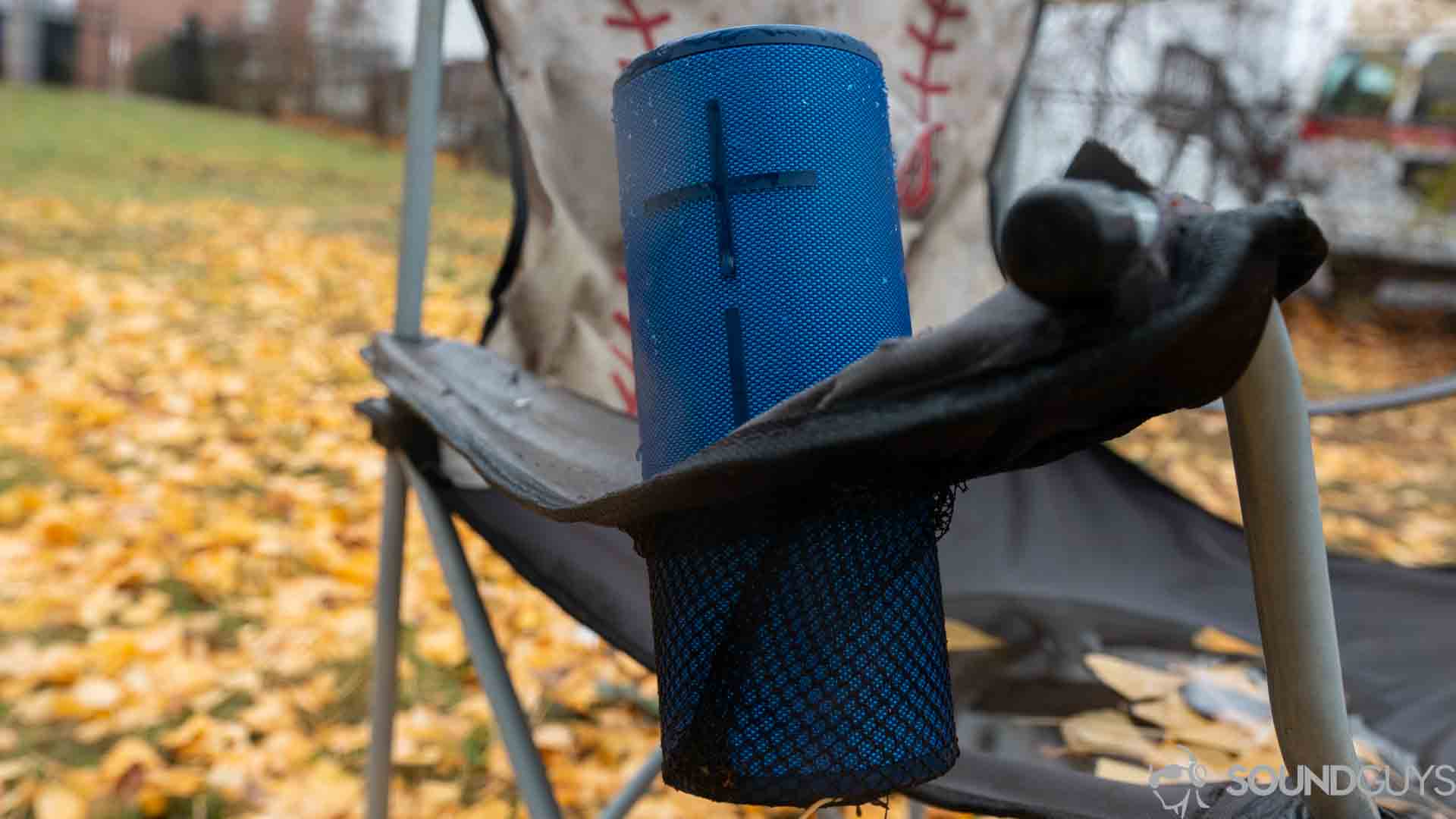 The UE Boom 3 pictured in a water bottle holder of a camping chair.