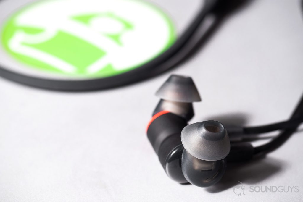 Plantronics BackBeat Go 410: Close-up of the earbuds magnetized together on a Microsoft Surface Book with an Android Authority sticker on it.