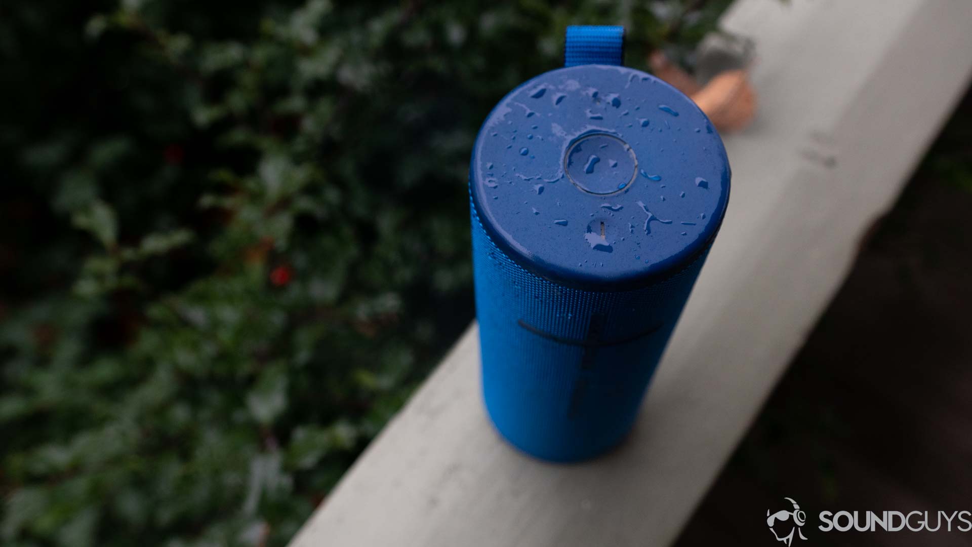 The top of the UE Boom 3 in blue showing its buttons and water splashes.