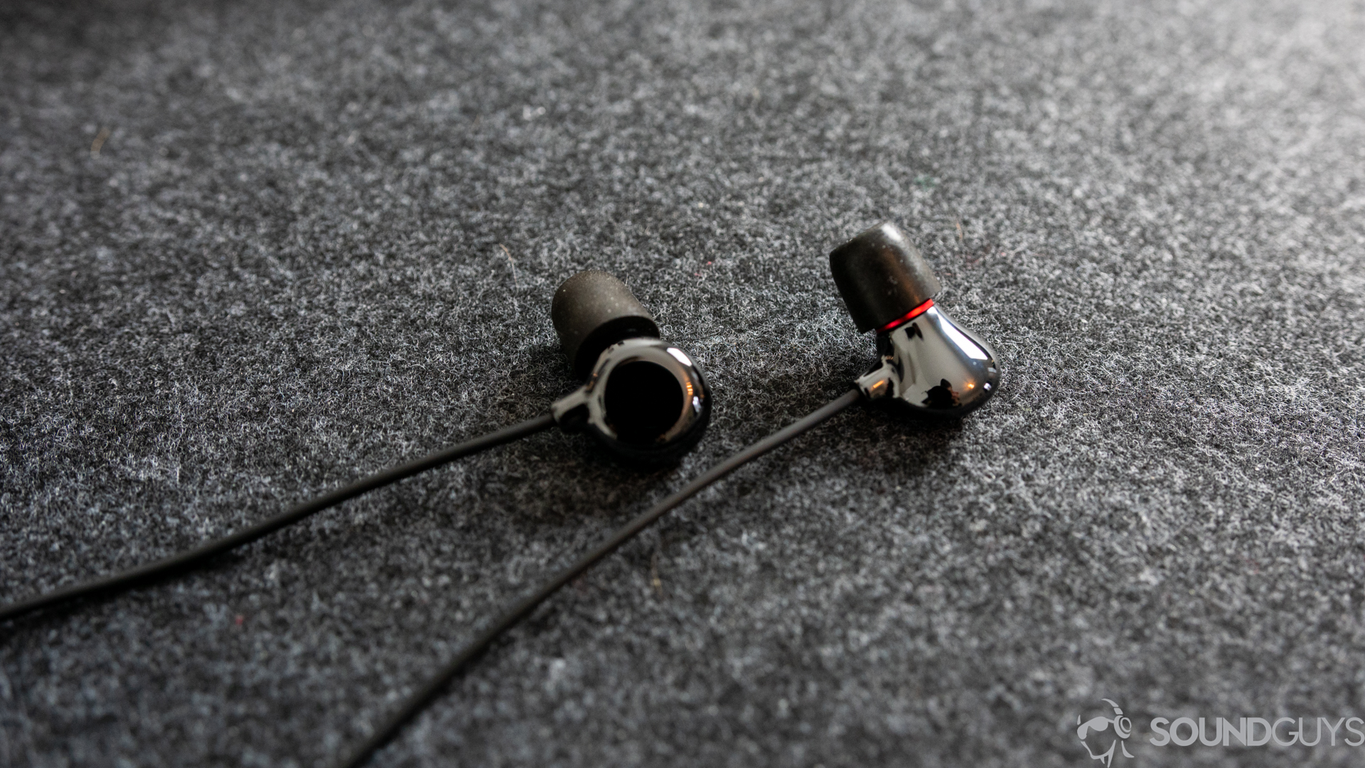 Pictured are the Elise earbuds from ADV.Sound on a desk.